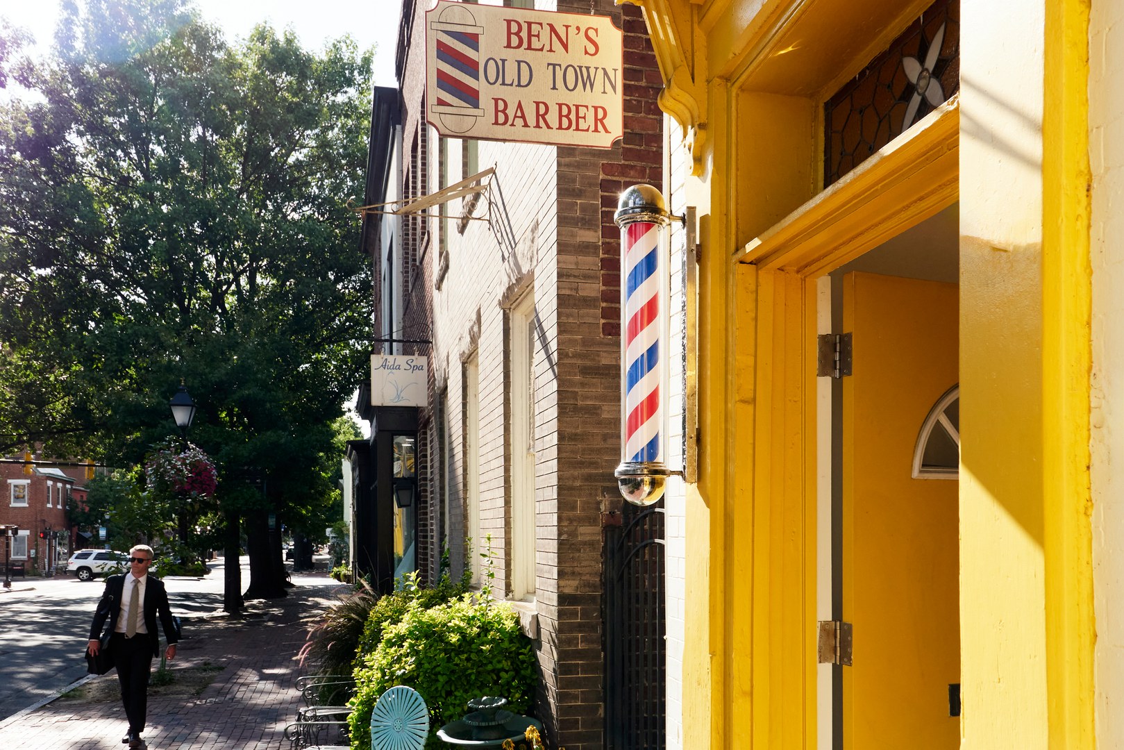 A street scene with Ben's Old Town Barber in the foreground and Aida Spa in the background